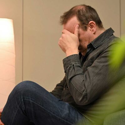 TLP-male-visitor-hands-on-face
