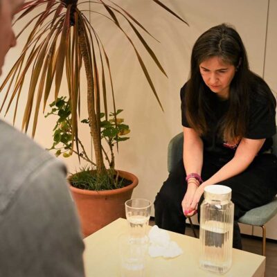 TLP-visitor-and-listening-volunteer-in-listening-room-and-table